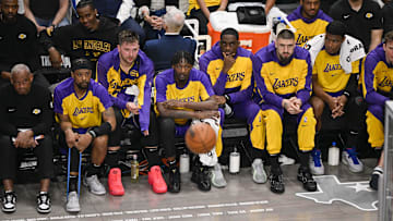 Apr 9, 2025; Dallas, Texas, USA; Los Angeles Lakers guard Luka Doncic (77) looks on from the team bench during the game between the Dallas Mavericks and the Los Angeles Lakers at American Airlines Center. Mandatory Credit: Jerome Miron-Imagn Images