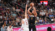 Mar 21, 2025; Phoenix, Arizona, USA; Phoenix Suns guard Devin Booker (1) shoots over Cleveland Cavaliers guard Sam Merrill (5) during the second half at Footprint Center. Mandatory Credit: Joe Camporeale-Imagn Images
