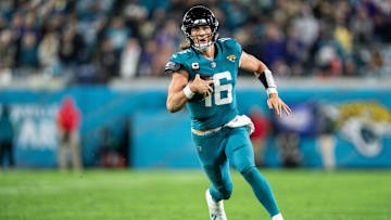 Dec 17, 2023; Jacksonville, Florida, USA; Jacksonville Jaguars quarterback Trevor Lawrence (16) runs the ball for a first down against the Baltimore Ravens in the fourth quarter at EverBank Stadium. Mandatory Credit: Jeremy Reper-USA TODAY Sports