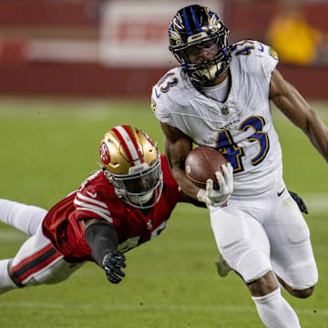 Dec 25, 2023; Santa Clara, California, USA; San Francisco 49ers linebacker Demetrius Flannigan-Fowles (45) makes a diving tackle on Baltimore Ravens running back Justice Hill (43) during the third quarter at Levi's Stadium. Mandatory Credit: Neville E. Guard-Imagn Images