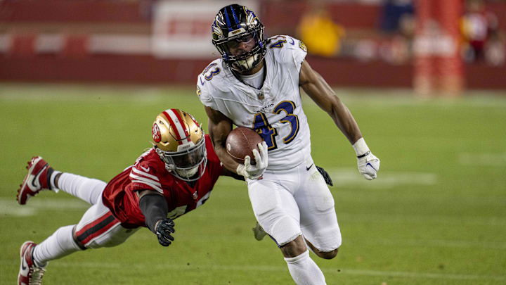 Dec 25, 2023; Santa Clara, California, USA; San Francisco 49ers linebacker Demetrius Flannigan-Fowles (45) makes a diving tackle on Baltimore Ravens running back Justice Hill (43) during the third quarter at Levi's Stadium. Mandatory Credit: Neville E. Guard-Imagn Images