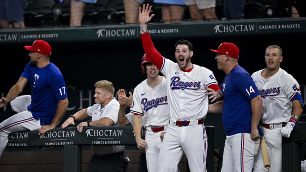 Rangers teammates react to Josh Smith's walk-off home run in the 10th inning Monday night.