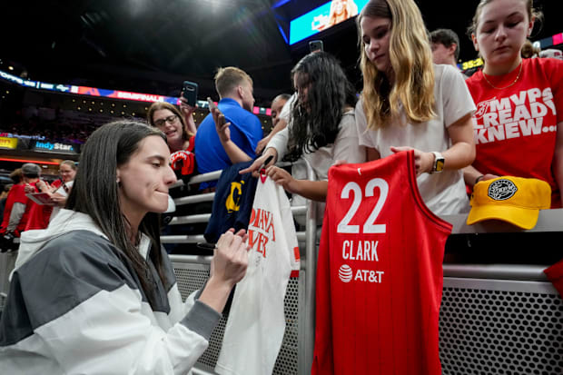 Indiana Fever guard Caitlin Clark signs autographs. 