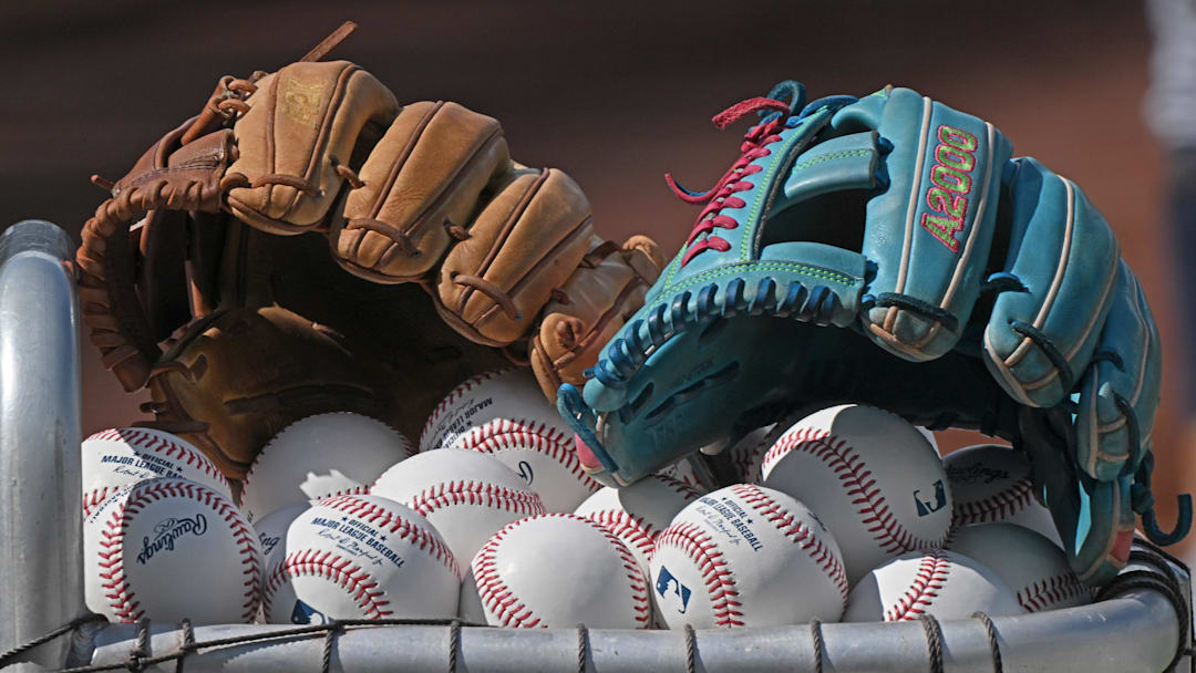 Jun 24, 2025; Kansas City, Missouri, USA;  A general view off baseball gloves and baseballs before a game between the Tampa Bay Rays and Kansas City Royals at Kauffman Stadium. Mandatory Credit: Peter Aiken-Imagn Images