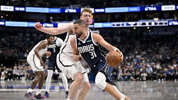 Dec 12, 2025; Dallas, Texas, USA; Dallas Mavericks guard Klay Thompson (31) drives to the basket past Brooklyn Nets forward Danny Wolf (2) during the second quarter at the American Airlines Center. Mandatory Credit: Jerome Miron-Imagn Images