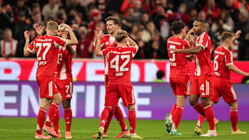 Bayern Munich players celebrating a goal against Bayer Leverkusen.