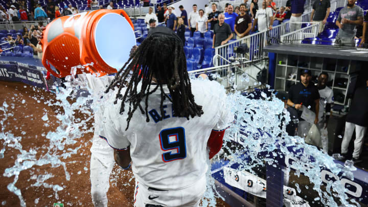 May 20, 2024; Miami, Florida, USA; Miami Marlins shortstop Vidal Brujan (17) dumps a Gatorade cooler over first baseman Josh Bell (9) after winning the game against the Milwaukee Brewers at loanDepot Park. 