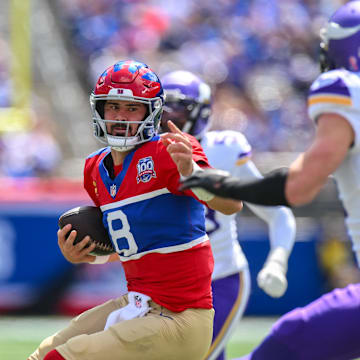 Sep 8, 2024; East Rutherford, New Jersey, USA; New York Giants quarterback Daniel Jones (8) carries the ball while being defended by Minnesota Vikings safety Harrison Smith (22) during the first half at MetLife Stadium.  