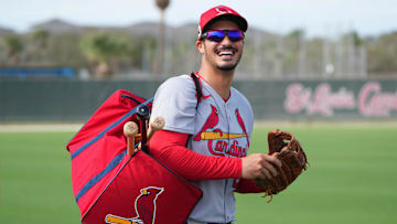 Feb 17, 2025; Jupiter, FL, USA;  St. Louis Cardinals third base Nolan Arenado (28) laughs as he heads off to a workout station at spring training.