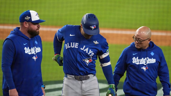 Oct 27, 2025; Los Angeles, California, USA; Toronto Blue Jays right fielder George Springer (4) leaves the game after an apparent injury in the seventh inning against the Los Angeles Dodgers during game three of the 2025 MLB World Series at Dodger Stadium. Mandatory Credit: Kirby Lee-Imagn Images