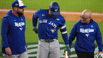 Oct 27, 2025; Los Angeles, California, USA; Toronto Blue Jays right fielder George Springer (4) leaves the game after an apparent injury in the seventh inning against the Los Angeles Dodgers during game three of the 2025 MLB World Series at Dodger Stadium. Mandatory Credit: Kirby Lee-Imagn Images