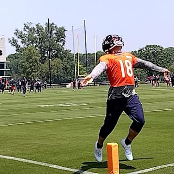 Caleb Williams drops the ball to celebrate after making a catch on  along pass as the Bears had QBs and linemen playing as receivers on the final day of minicamp in drills.