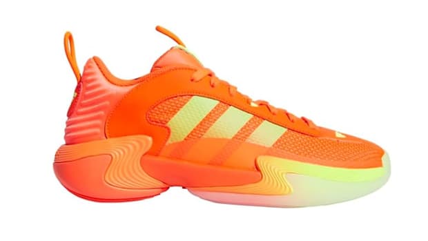 Orange and yellow adidas basketball shoes.
