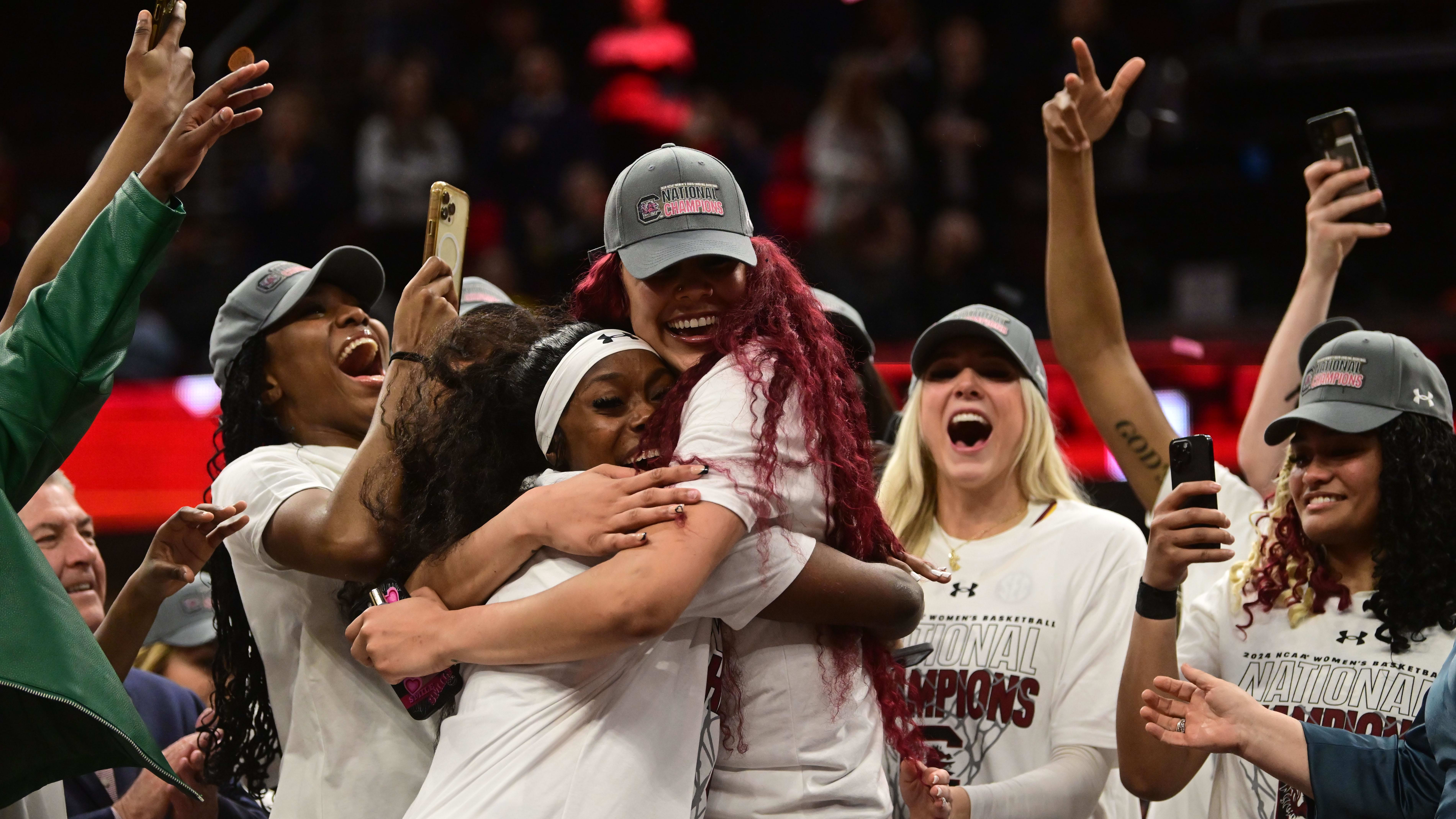 Johnson and Cardoso embrace after winning the national championship.