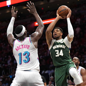 Apr 5, 2025; Miami, Florida, USA;  Milwaukee Bucks forward Giannis Antetokounmpo (34) looks to pass the ball as Miami Heat center Bam Adebayo (13) defends during overtime at Kaseya Center. Mandatory Credit: Jim Rassol-Imagn Images