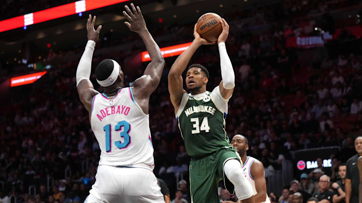 Apr 5, 2025; Miami, Florida, USA; Milwaukee Bucks forward Giannis Antetokounmpo (34) looks to pass the ball as Miami Heat center Bam Adebayo (13) defends during overtime at Kaseya Center. Mandatory Credit: Jim Rassol-Imagn Images