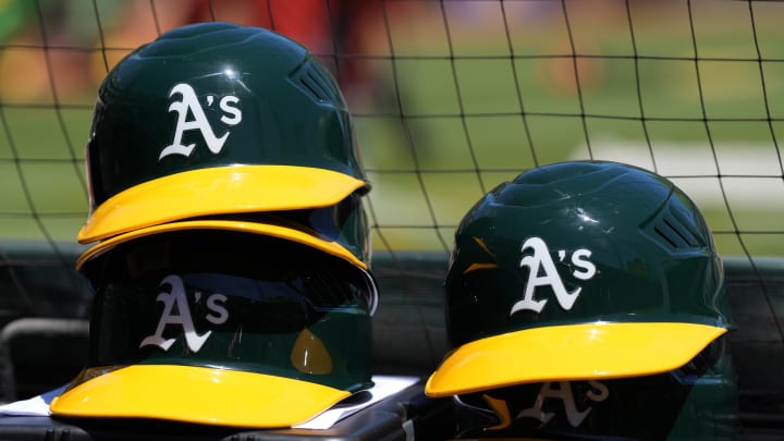 May 29, 2022; Oakland, California, USA; Oakland Athletics helmets are stacked near the field before the game against the Texas Rangers at RingCentral Coliseum. Mandatory Credit: Darren Yamashita-USA TODAY Sports