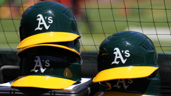 May 29, 2022; Oakland, California, USA; Oakland Athletics helmets are stacked near the field before the game against the Texas Rangers at RingCentral Coliseum. Mandatory Credit: Darren Yamashita-USA TODAY Sports