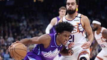 Dec 13, 2024; Salt Lake City, Utah, USA; Utah Jazz guard Collin Sexton (2) drives against Phoenix Suns guard Tyus Jones (21) during the first quarter at Delta Center. Mandatory Credit: Rob Gray-Imagn Images