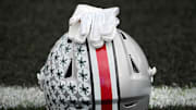 Oct. 14, 2023; Lafayette, In., USA; 
Gloves lie on top of the helmet of Ohio State Buckeyes wide receiver Julian Fleming (4) before Saturday's NCAA Division I football game against the Purdue Boilermakers at Ross-Ade Stadium in Lafayette.