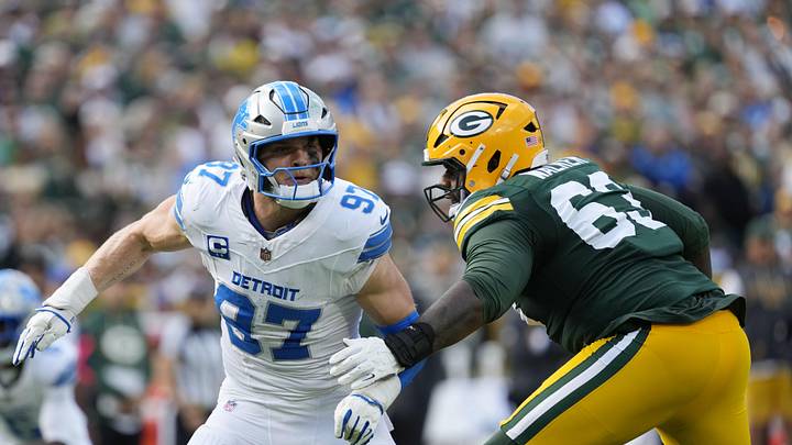 Sep 7, 2025; Green Bay, Wisconsin, USA; Detroit Lions defensive end Aidan Hutchinson (97) fights for position with Green Bay Packers offensive tackle Rasheed Walker (63) during the second quarter at Lambeau Field. Mandatory Credit: Jeff Hanisch-Imagn Images