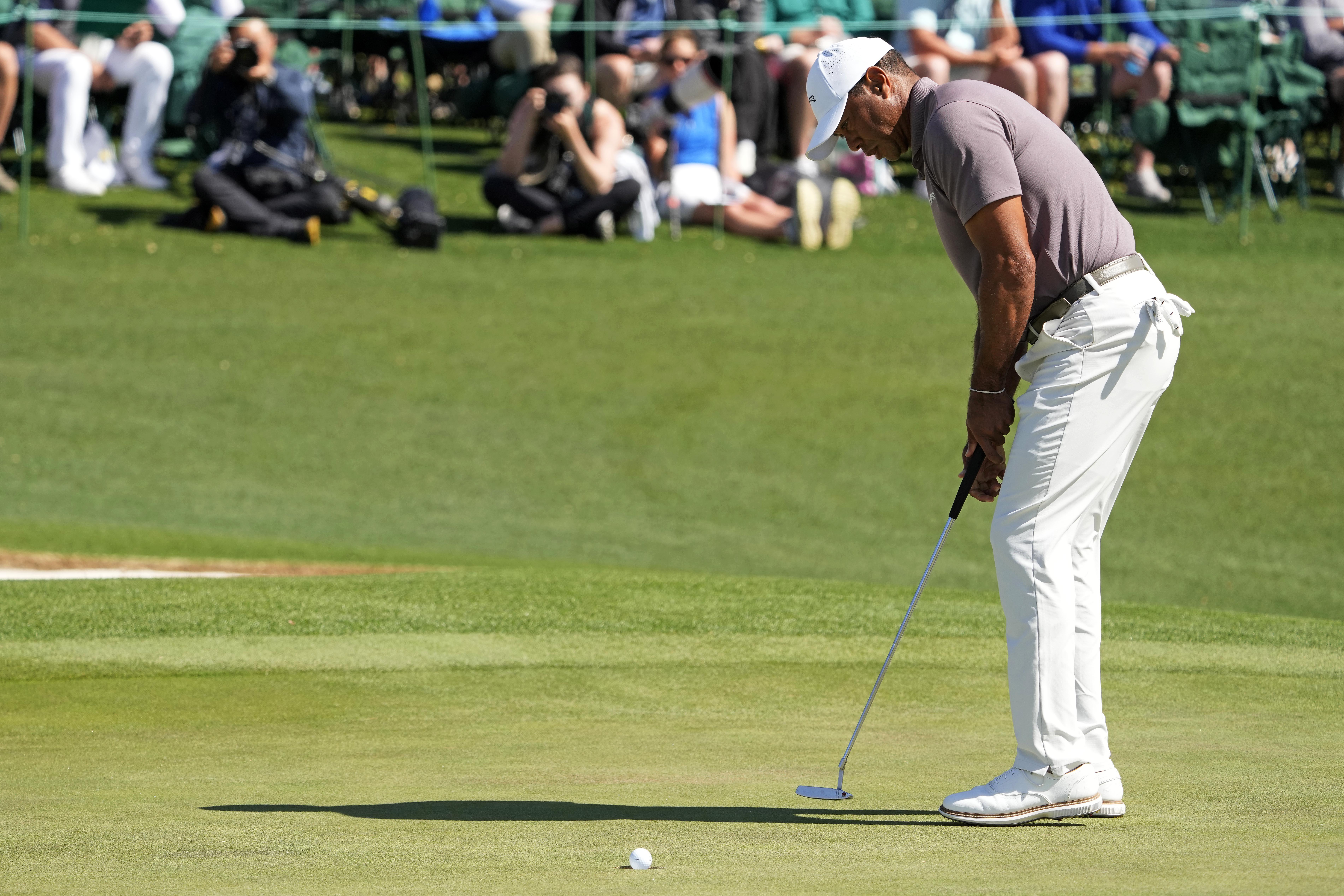 Tiger Woods putts on the green at The Masters.