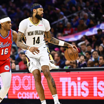 Mar 8, 2024; Philadelphia, Pennsylvania, USA; New Orleans Pelicans forward Brandon Ingram (14) spins with the ball against Philadelphia 76ers guard Ricky Council IV (16) in the second quarter at Wells Fargo Center. Mandatory Credit: Kyle Ross-USA TODAY Sports