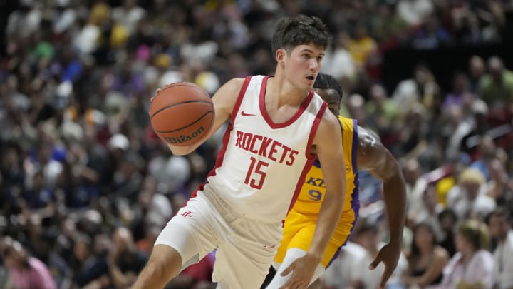 Jul 12, 2024; Las Vegas, NV, USA;  Houston Rockets guard Reed Sheppard (15) dribbles the ball against Los Angeles Lakers guard Bronny James (9) during the first half at the Thomas & Mack Center. Mandatory Credit: Lucas Peltier-USA TODAY Sports