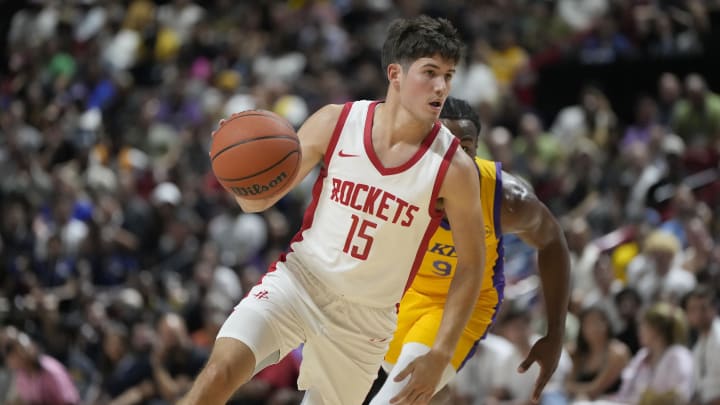 Jul 12, 2024; Las Vegas, NV, USA;  Houston Rockets guard Reed Sheppard (15) dribbles the ball against Los Angeles Lakers guard Bronny James (9) during the first half at the Thomas & Mack Center. Mandatory Credit: Lucas Peltier-USA TODAY Sports