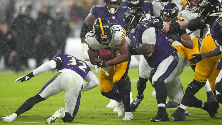 Jan 6, 2024; Baltimore, Maryland, USA; Pittsburgh Steelers  running back Najee Harris (23) gains yardage in the first quarter defended by Baltimore Ravens tackle Travis Jones (98) at M&T Bank Stadium. Mandatory Credit: Mitch Stringer-USA TODAY Sports