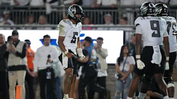Sep 27, 2025; University Park, Pennsylvania, USA; Oregon Ducks quarterback Dante Moore (5) reacts after a touchdown with tight end Jamari Johnson (9) and offensive lineman Emmanuel Pregnon (75) at Beaver Stadium. Mandatory Credit: James Lang-Imagn Images