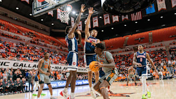 Jan 21, 2025; Stillwater, Oklahoma, USA; Oklahoma State Cowboys forward Marchelus Avery (0) is blocked by Arizona Wildcats center Motiejus Krivas (14) and forward Carter Bryant (9) during the first half at Gallagher-Iba Arena. Mandatory Credit: William Purnell-Imagn Images