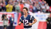 New England Patriots former quarterback Tom Brady runs on the field during a halftime ceremony in his honor during the game between the Philadelphia Eagles and New England Patriots at Gillette Stadium. 