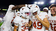 Oct 18, 2025; Lexington, Kentucky, USA; Texas Longhorns wide receiver Jaime Ffrench Jr. (2) and wide receiver Rett Andersen (35) celebrate with kicker Mason Shipley (49) after Shipley scored the winning field goal in overtime against the Kentucky Wildcats at Kroger Field. Mandatory Credit: Jordan Prather-Imagn Images