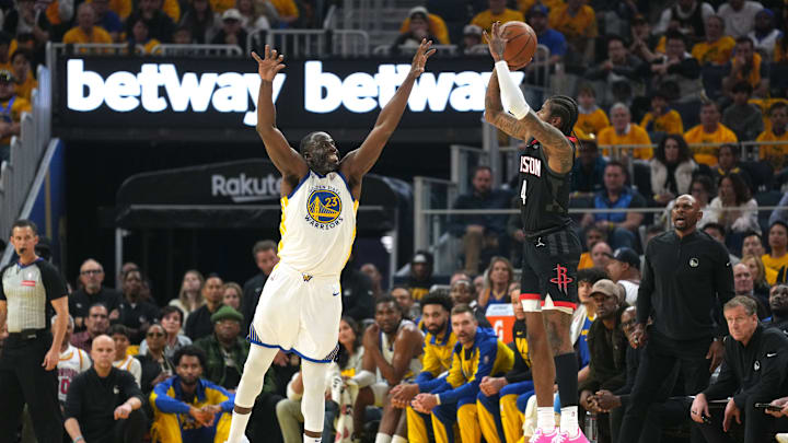 Houston Rockets guard Jalen Green (4) shoots against Golden State Warriors forward Draymond Green. Houston Rockets guard Jalen Green (4) shoots against Golden State Warriors forward Draymond Green.