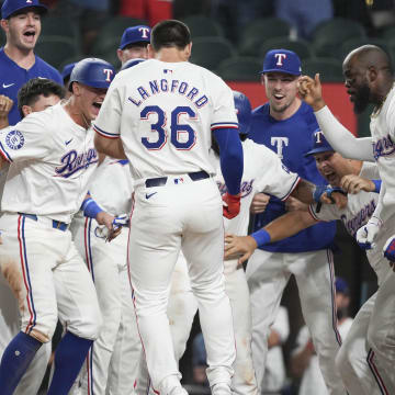 Sep 3, 2024; Arlington, Texas, USA; Texas Rangers center fielder Wyatt Langford (36) arrives home to teammates on his grand slam walk-off against the New York Yankees during the ninth inning at Globe Life Field. Mandatory Credit: Jim Cowsert-Imagn Images