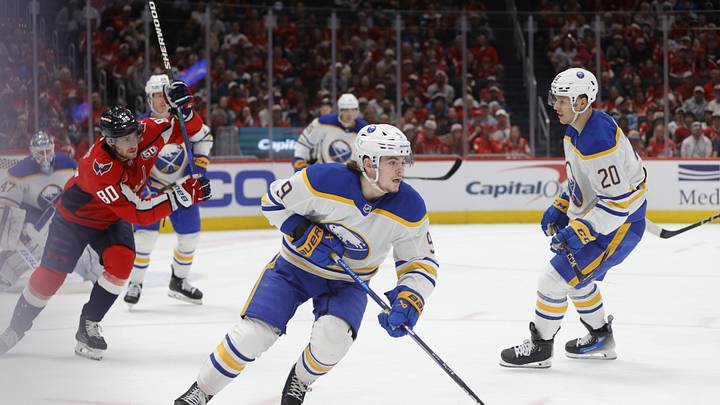 Mar 29, 2025; Washington, District of Columbia, USA; Buffalo Sabres left wing Zach Benson (9) skates with the puck past Washington Capitals left wing Pierre-Luc Dubois (80) during the second half at Audi Field. Mandatory Credit: Amber Searls-Imagn Images