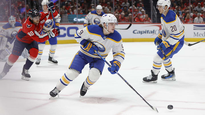 Mar 29, 2025; Washington, District of Columbia, USA; Buffalo Sabres left wing Zach Benson (9) skates with the puck past Washington Capitals left wing Pierre-Luc Dubois (80) during the second half at Audi Field. Mandatory Credit: Amber Searls-Imagn Images