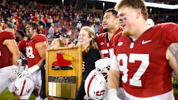 Nov 22, 2025; Stanford, California, USA; Stanford Cardinal players take possession of the axe after the game against the California Golden Bears at Stanford Stadium. Mandatory Credit: Sergio Estrada-Imagn Images