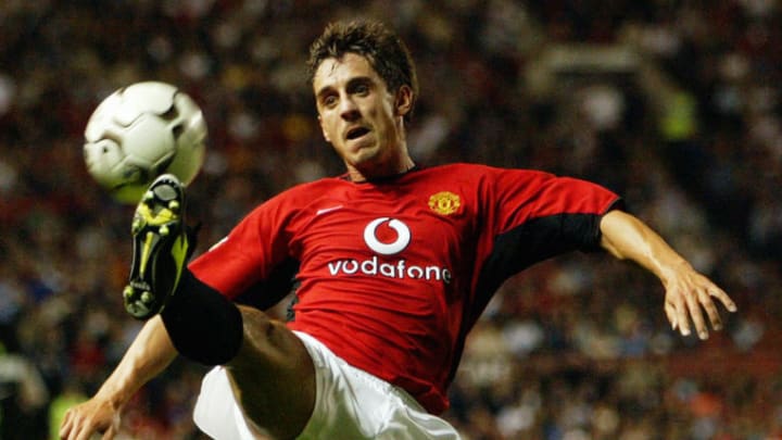 Gary Neville of Manchester United attempts to take control of the ball in mid-air