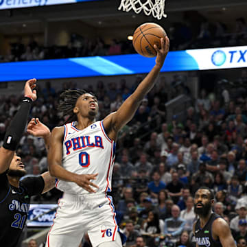 Mar 3, 2024; Dallas, Texas, USA; Philadelphia 76ers guard Tyrese Maxey (0) drives to the basket past Dallas Mavericks center Daniel Gafford (21) during the first half at the American Airlines Center. Mandatory Credit: Jerome Miron-Imagn Images