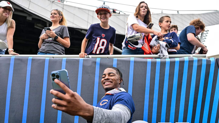 Jaquan Brisker poses with fans at Soldier Field in the third preseason game. Despite injuries, he says he and the defense are ready.