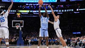 Dec 21, 2024; New York, NY, USA; North Carolina Tar Heels guard Ian Jackson (11) shoots the ball while being defended by UCLA Bruins guard Kobe Johnson (0) during the second half at Madison Square Garden. Mandatory Credit: John Jones-Imagn Images
