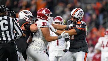 Nov 1, 2025; Corvallis, Oregon, USA; Washington State Cougars defensive lineman Malaki Ta'Ase (98) with a personal foul for unnecessary roughness locked up with Oregon State Beavers offensive lineman Jayden Tuia (67) at Reser Stadium. Mandatory Credit: Craig Strobeck-Imagn Images