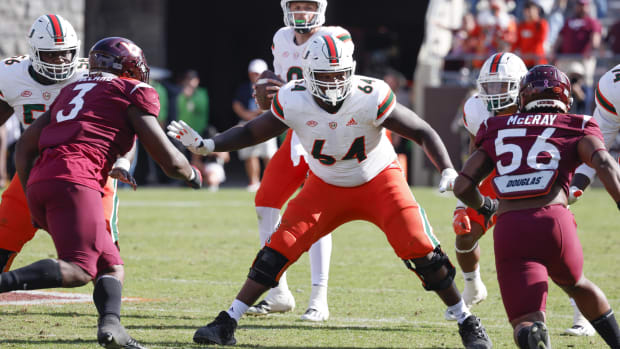 Miami Hurricanes offensive lineman Jalen Rivers (64) guards the line against Virginia Tech Hokies defensive linemen Norell Po