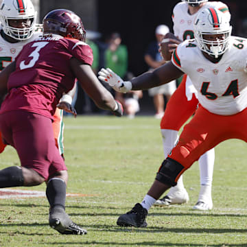 Oct 15, 2022; Blacksburg, Virginia, USA;  Miami Hurricanes offensive lineman Jalen Rivers (64) guards the line against Virginia Tech Hokies defensive linemen Norell Pollard (3) and C.J. McCray (56) during the second half at Lane Stadium. Mandatory Credit: Reinhold Matay-Imagn Images