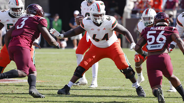 Oct 15, 2022; Blacksburg, Virginia, USA;  Miami Hurricanes offensive lineman Jalen Rivers (64) guards the line against Virginia Tech Hokies defensive linemen Norell Pollard (3) and C.J. McCray (56) during the second half at Lane Stadium. Mandatory Credit: Reinhold Matay-Imagn Images