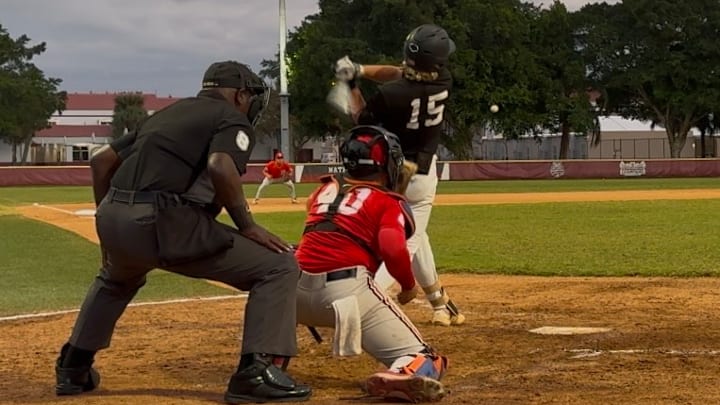 Michael Ossenfort of Stoneman Douglas delivers as base hit in a Fall scrimmage game against Doral Academy