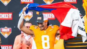 Jan 1, 2024; Orlando, FL, USA;  Tennessee Volunteers quarterback Nico Iamaleava (8) lifts the Tennessee state flag after the win over the Iowa Hawkeyes at Camping World Stadium. Mandatory Credit: Jeremy Reper-USA TODAY Sports