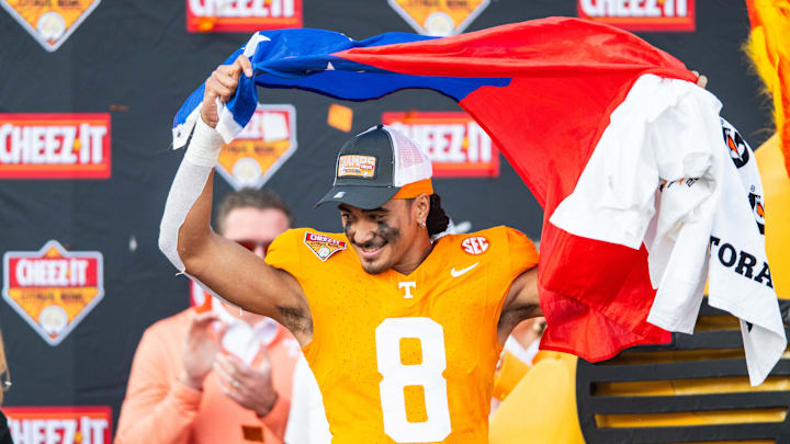 Jan 1, 2024; Orlando, FL, USA;  Tennessee Volunteers quarterback Nico Iamaleava (8) lifts the Tennessee state flag after the win over the Iowa Hawkeyes at Camping World Stadium. Mandatory Credit: Jeremy Reper-USA TODAY Sports